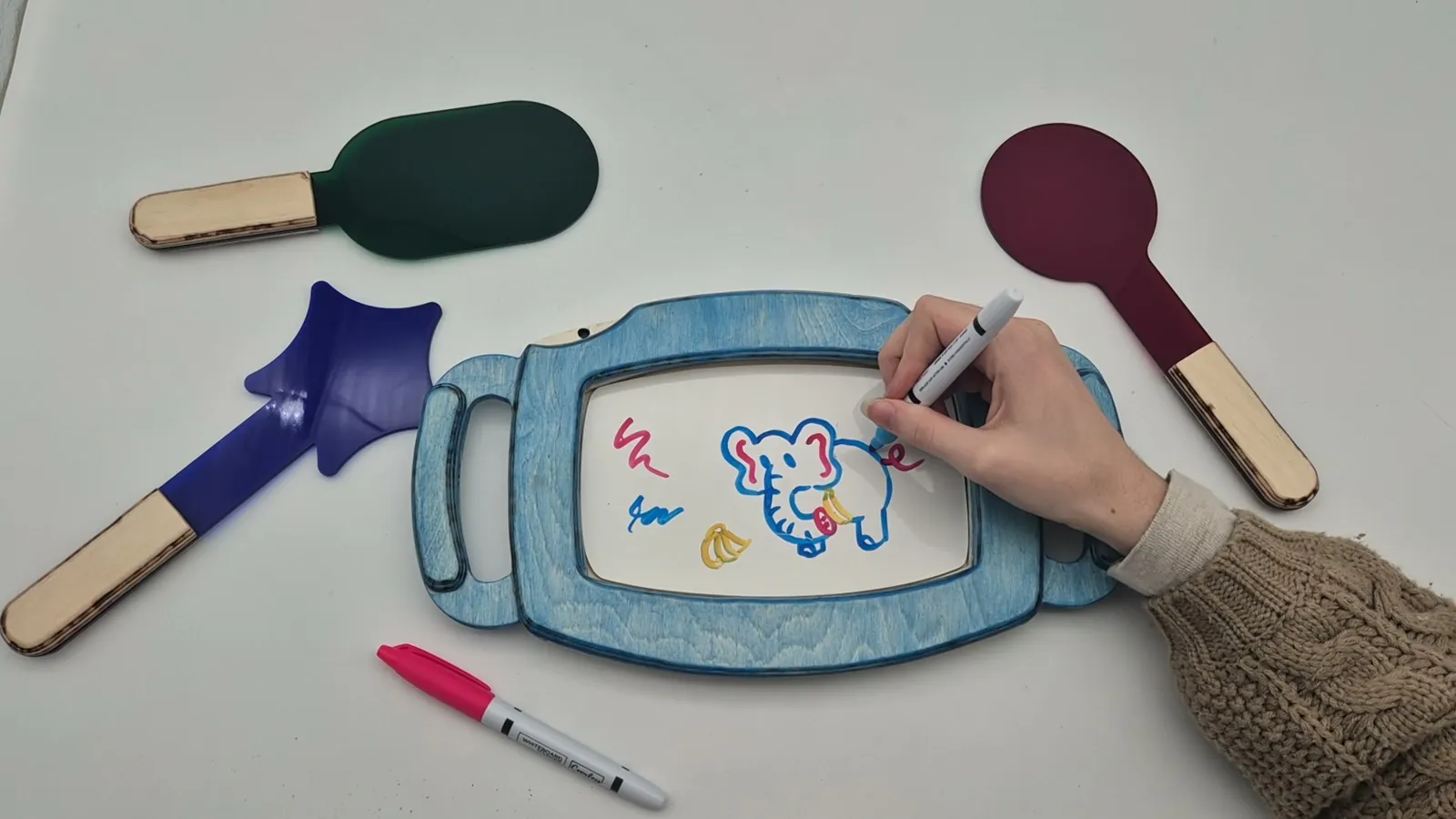 Still from the product video: a hand drawing on the frame with a marker