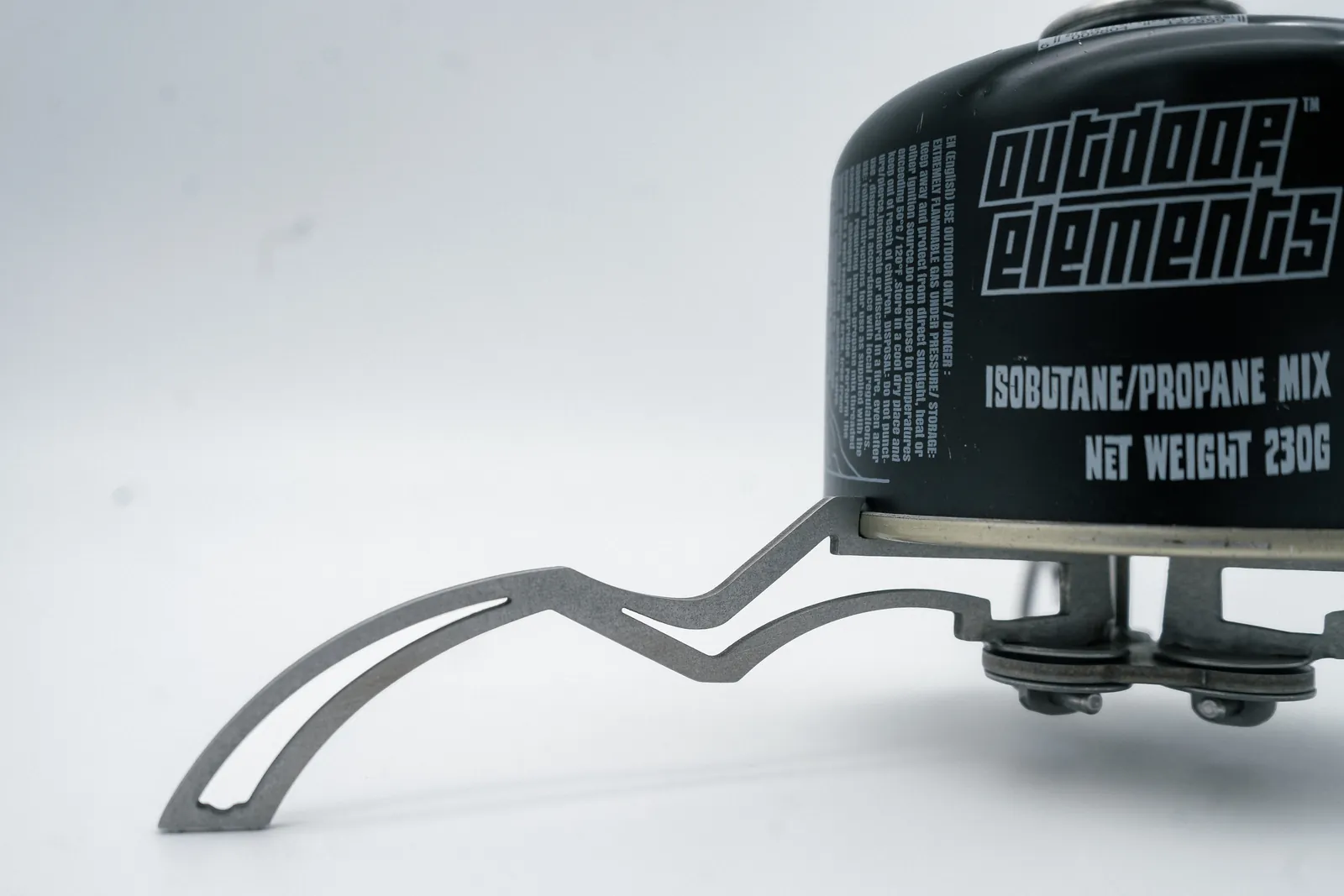 A stainless leg of the Argo Multistand clipped under an isobutane canister