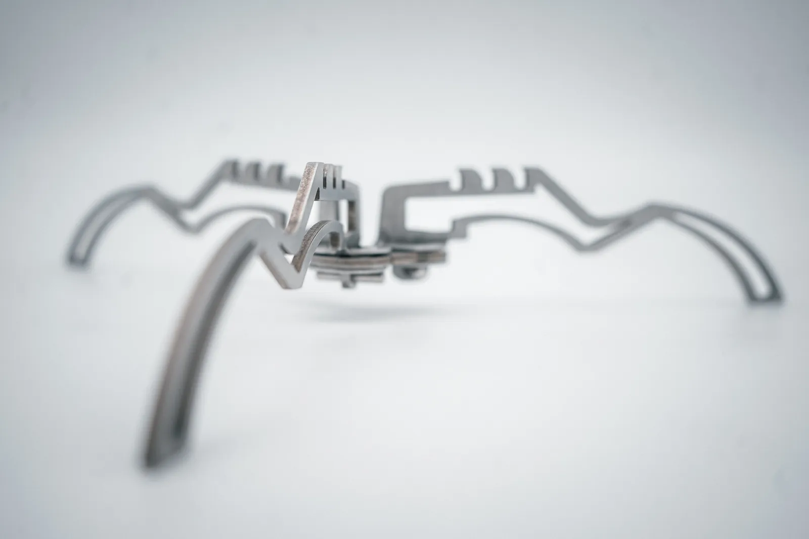 The three laser-cut stainless legs opened out on a white background