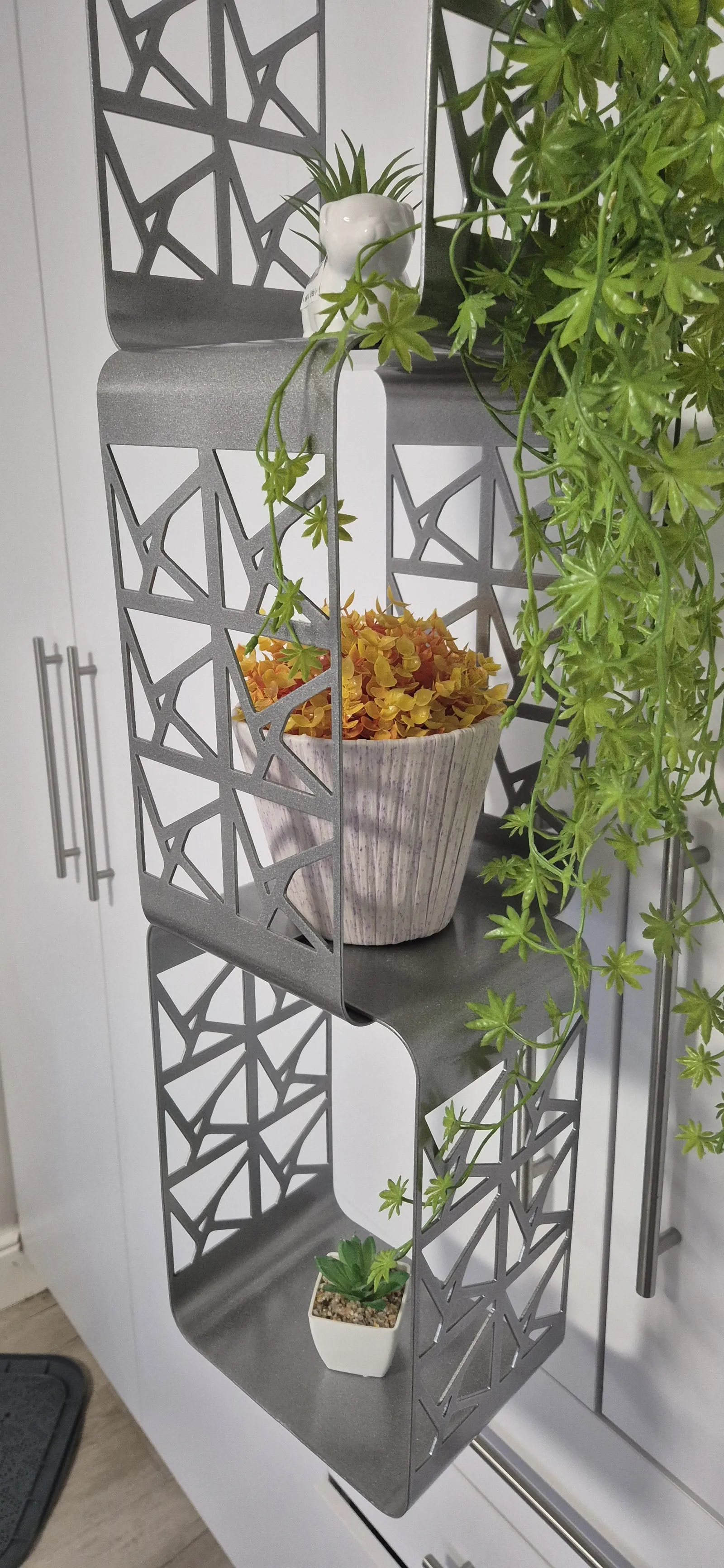 The steel GardenTower hanging with trailing plants